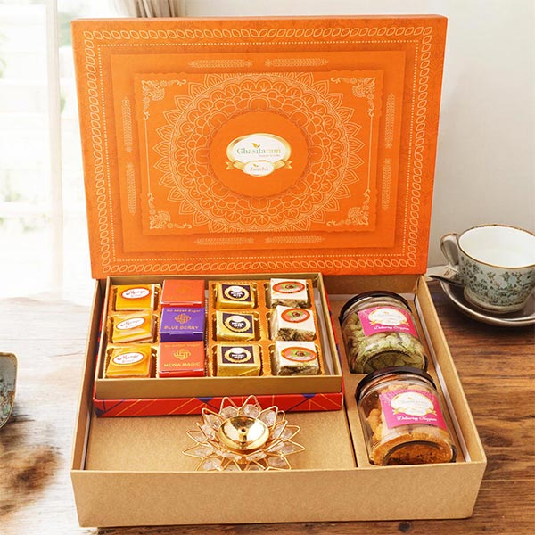 Orange Hamper box with Bites, Cashew, Flavour raisins and Diya